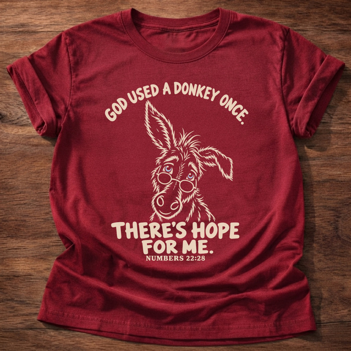 Cherry Red t-shirt printed with a hand-drawn donkey and “God used a donkey once. There's hope for me.” Numbers 22:28 Christian shirt
