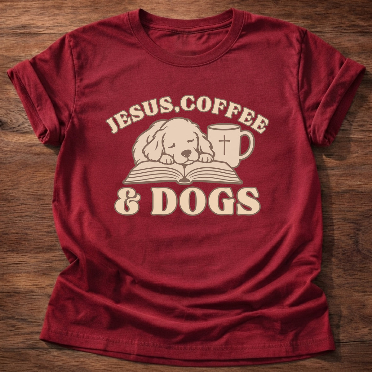 Cherry Red t-shirt printed with a sleepy puppy resting on an open Bible beside a coffee mug with a cross and “Jesus, Coffee & Dogs” Christian shirt
