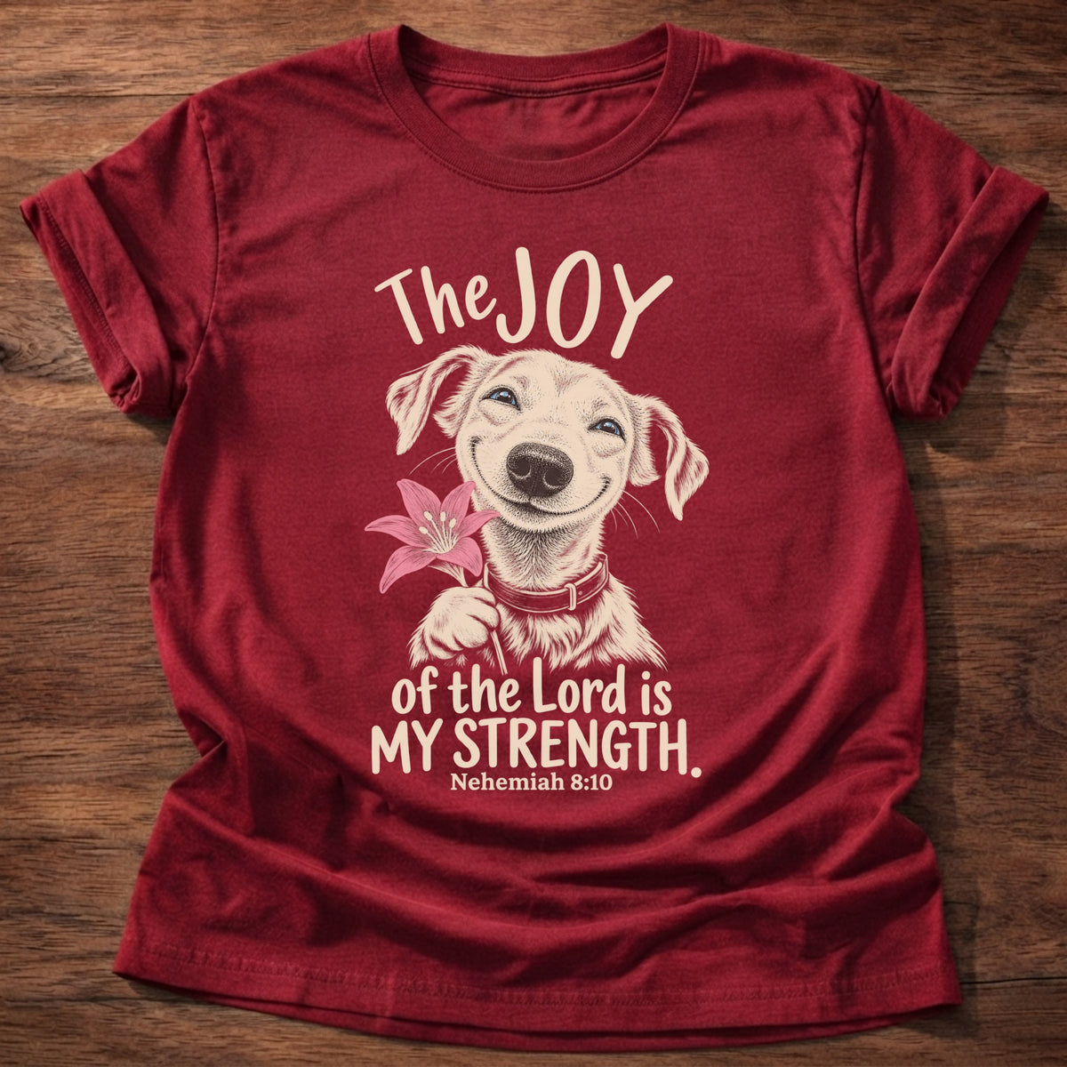 Cherry Red t-shirt printed with a happy smiling pup holding a flower graphic and “The joy of the Lord is my strength.” Nehemiah 8:10 Christian shirt