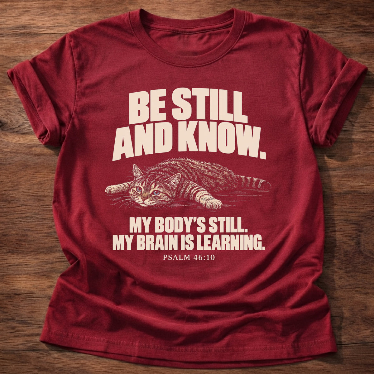 Brain Is Learning T-Shirt in Cherry Red featuring a relaxed cat stretched out lying down and Psalm 46:10 overthinking humor design