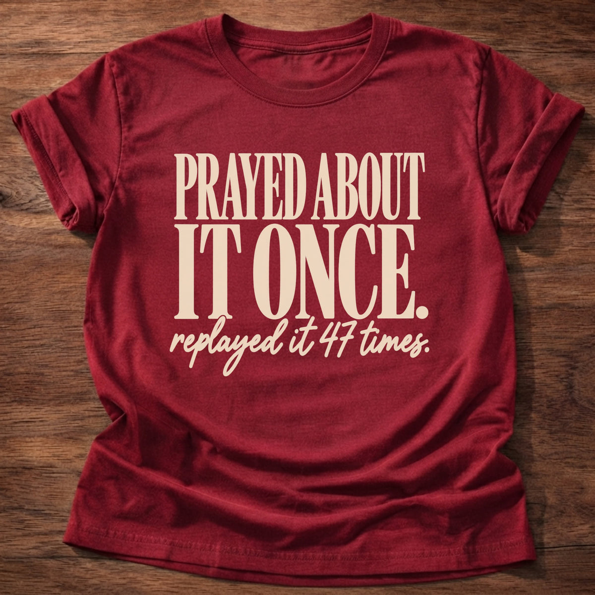 Replayed It Forty-Seven T-Shirt in Cherry Red featuring Prayed About It Once replayed it 47 times funny Christian overthinker typography design with script punchline