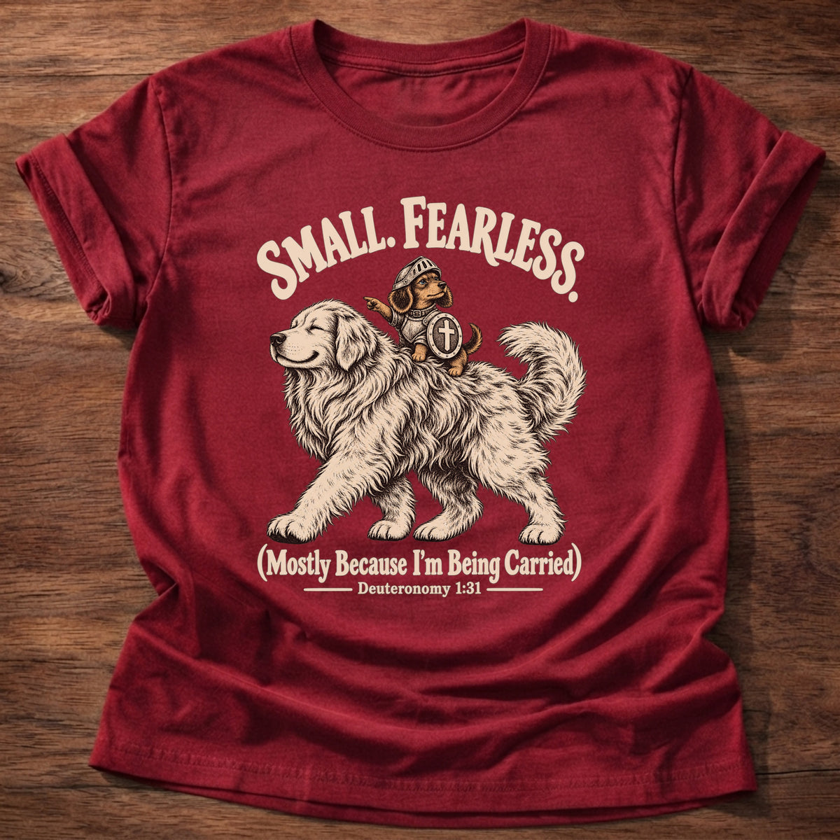 Cherry Red t-shirt printed with a tiny brave rider on a big fluffy dog graphic and “Small. Fearless. (Mostly because I'm being carried.)” Deuteronomy 1:31 Christian shirt