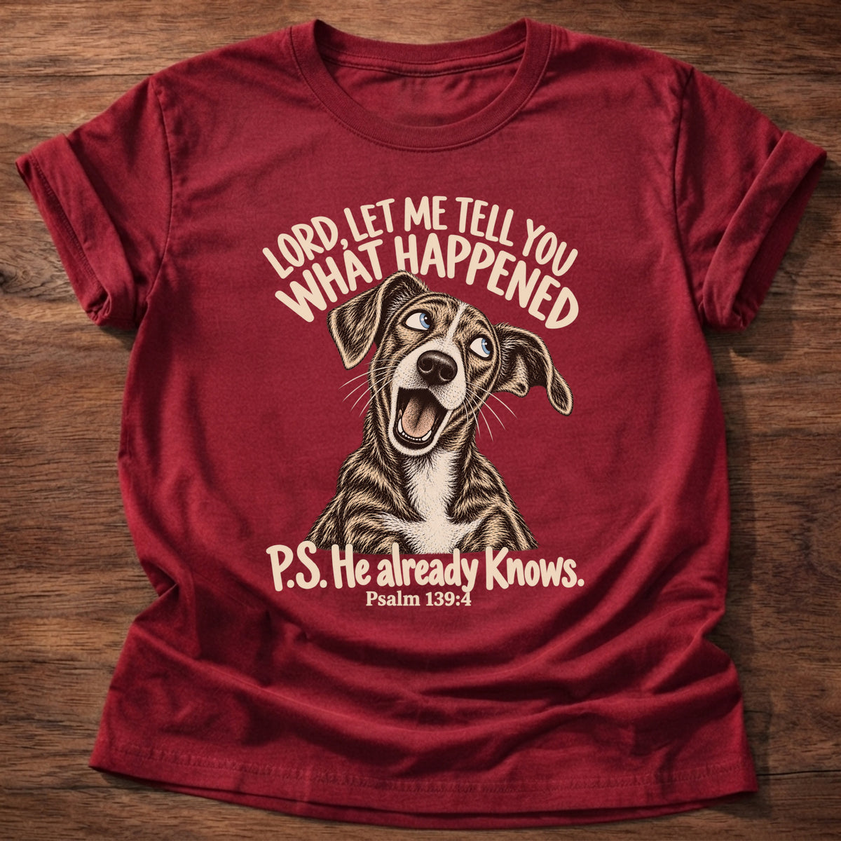 Cherry Red t-shirt printed with a wide-eyed storytelling dog graphic and “Lord, let me tell you what happened. P.S. He already knows.” Psalm 139:4 Christian shirt