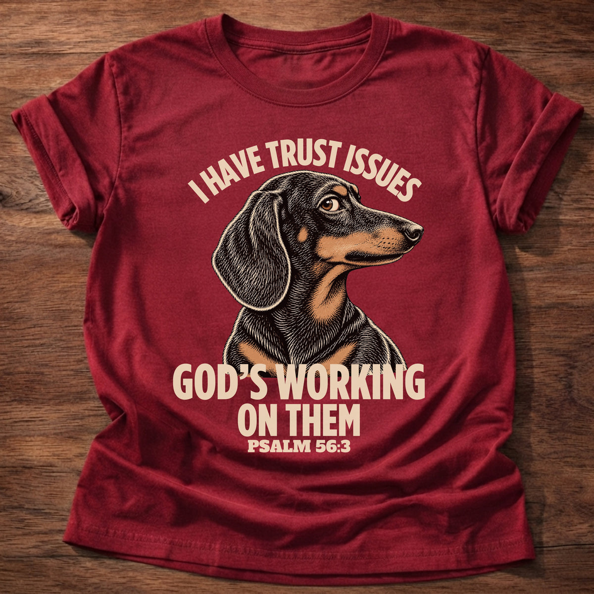 Cherry Red t-shirt printed with a wary dachshund puppy and “I have trust issues. God's working on them.” Psalm 56:3 Christian shirt