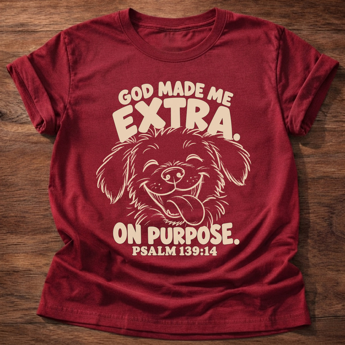 Cherry Red t-shirt printed with a fluffy, happy dog with its tongue out and “God made me extra. On purpose.” Psalm 139:14 Christian shirt