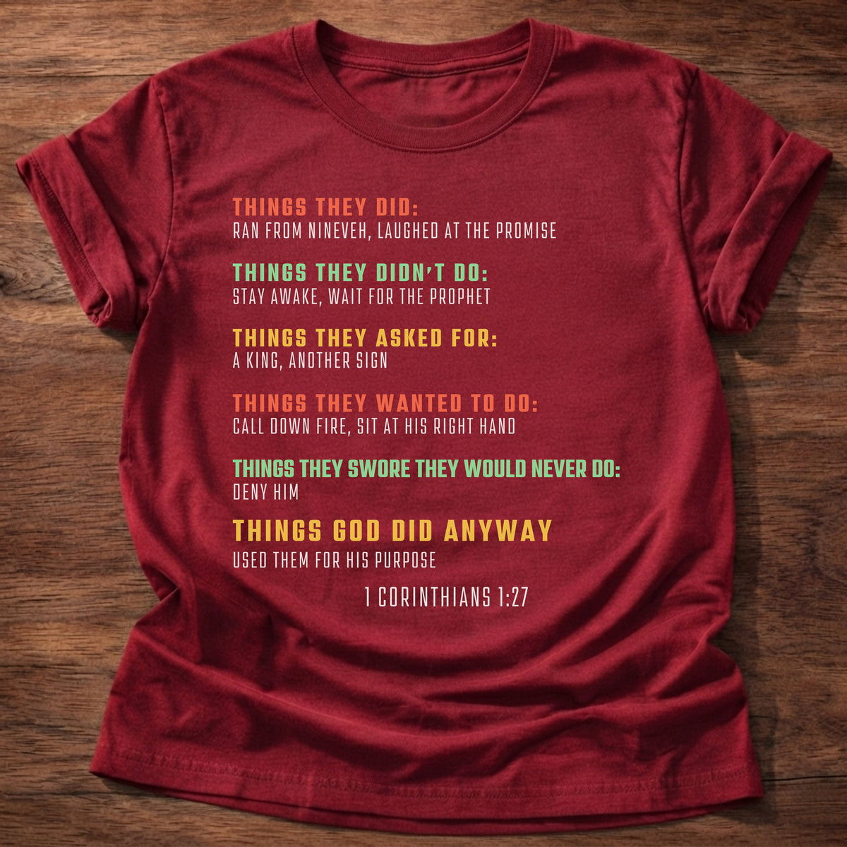 Cherry Red t-shirt printed with bold colorful typography listing what Bible heroes did graphic and “Things they did. Things God did anyway.” 1 Corinthians 1:27 Christian shirt