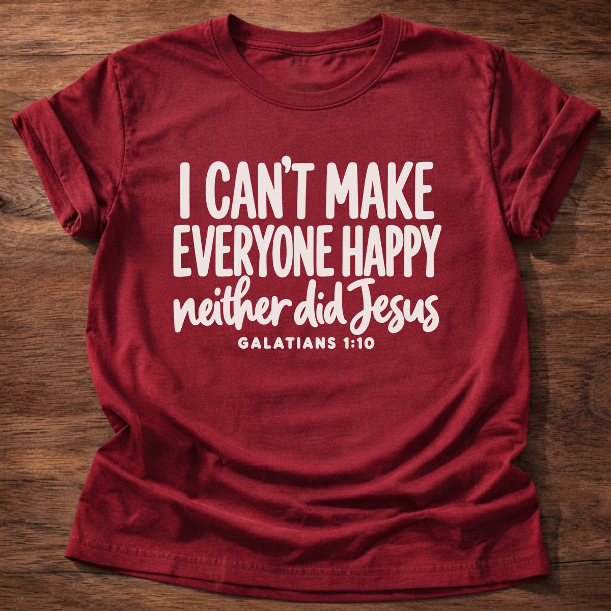 Cherry Red t-shirt printed with bold hand-lettered typography graphic and “I can't make everyone happy. Neither did Jesus.” Galatians 1:10 Christian shirt