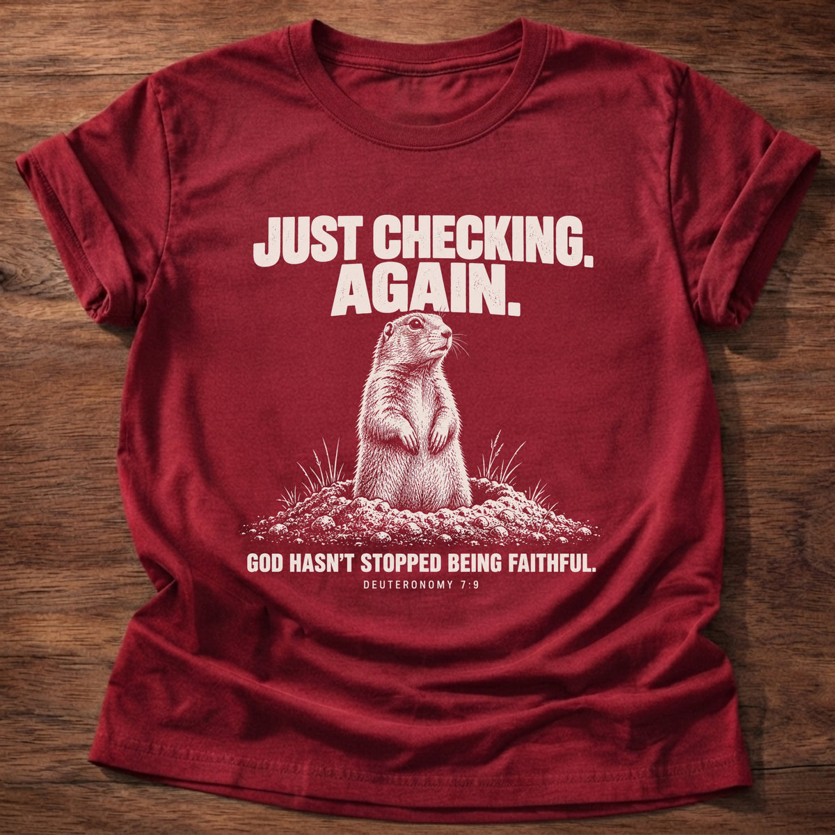 Cherry Red t-shirt printed with a prairie dog popping up out of its burrow graphic and 'Just checking. Again. God hasn't stopped being faithful.' Deuteronomy 7:9 faith based gift