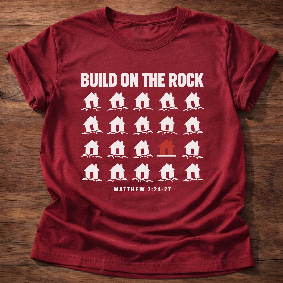 Cherry Red t-shirt printed with a row of houses graphic and 'Build on the rock.' Matthew 7:24-27 faith based gift