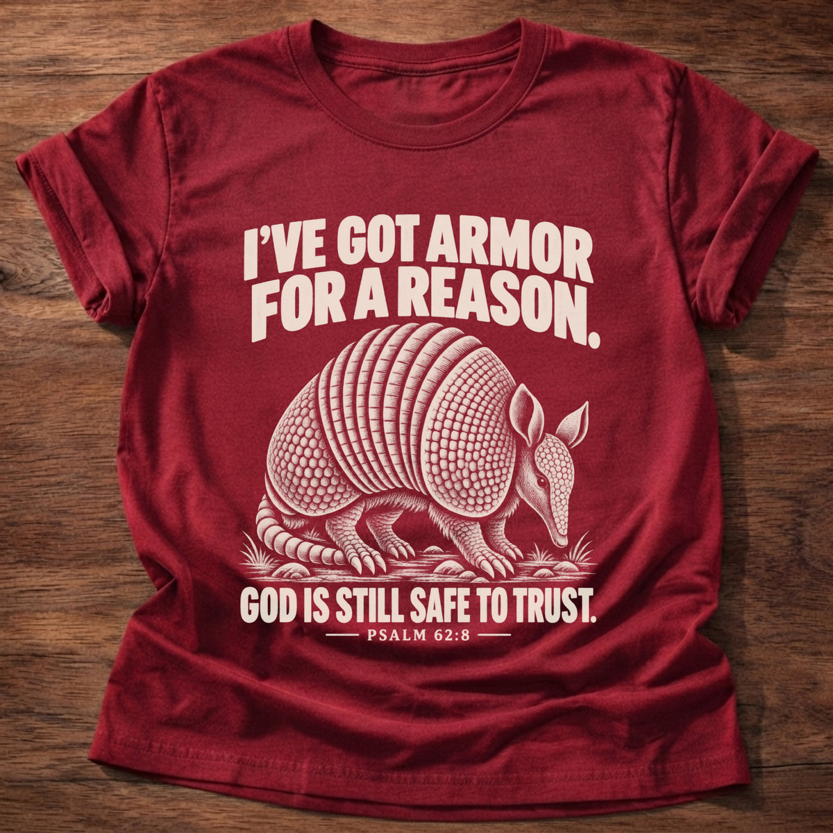 Cherry Red t-shirt printed with an armadillo in full armor graphic and 'I've got armor for a reason. God is still safe to trust.' Psalm 62:8 faith based gift
