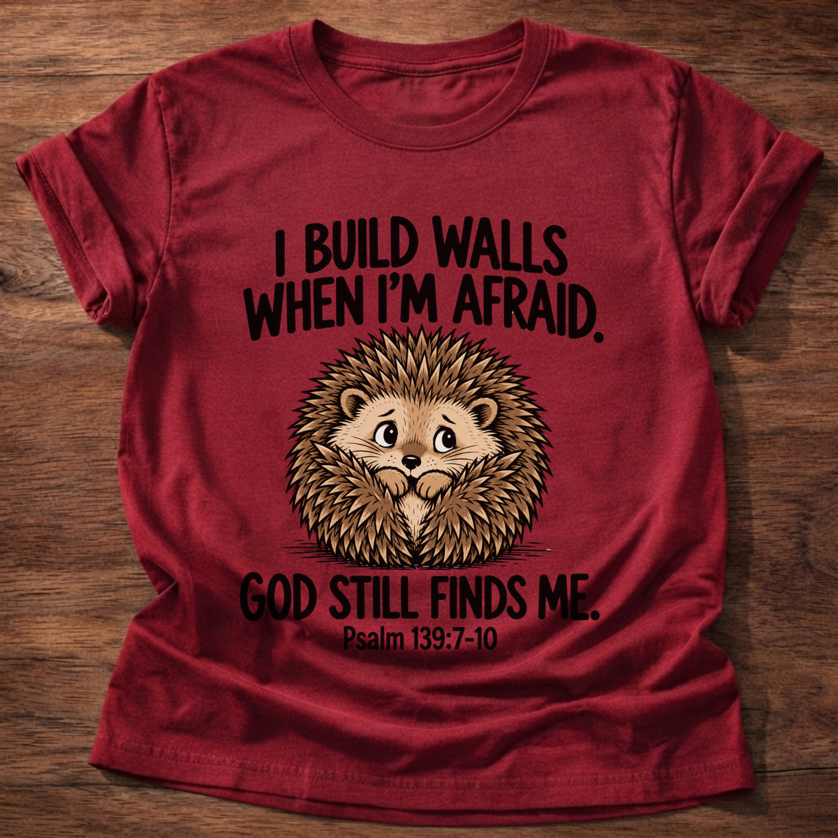 Cherry Red t-shirt printed with a hedgehog curled into a ball and 'I build walls when I'm afraid. God still finds me.' Psalm 139:7-10 faith based gift