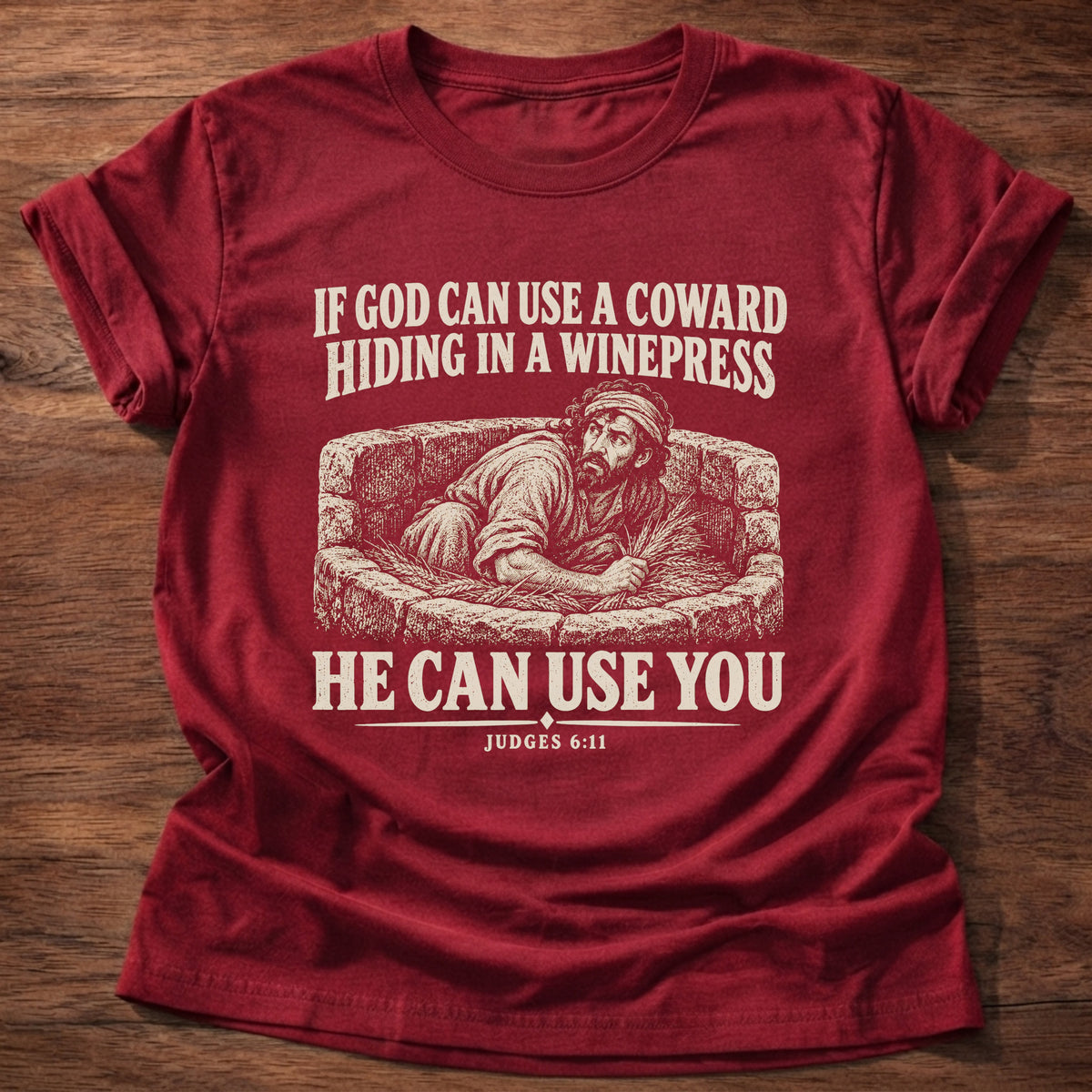 Cherry Red t-shirt printed with Gideon hiding in a winepress graphic and 'If God can use a coward hiding in a winepress, He can use you.' Judges 6:11 faith based gift