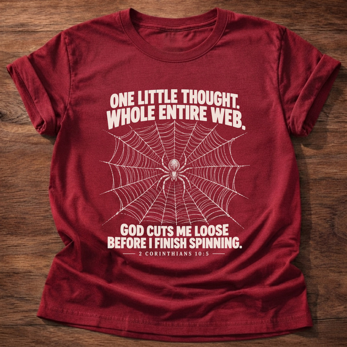 Cherry Red t-shirt printed with a spider at the center of its web graphic and 'One little thought. Whole entire web. God cuts me loose before I finish spinning.' 2 Corinthians 10:5 faith based gift