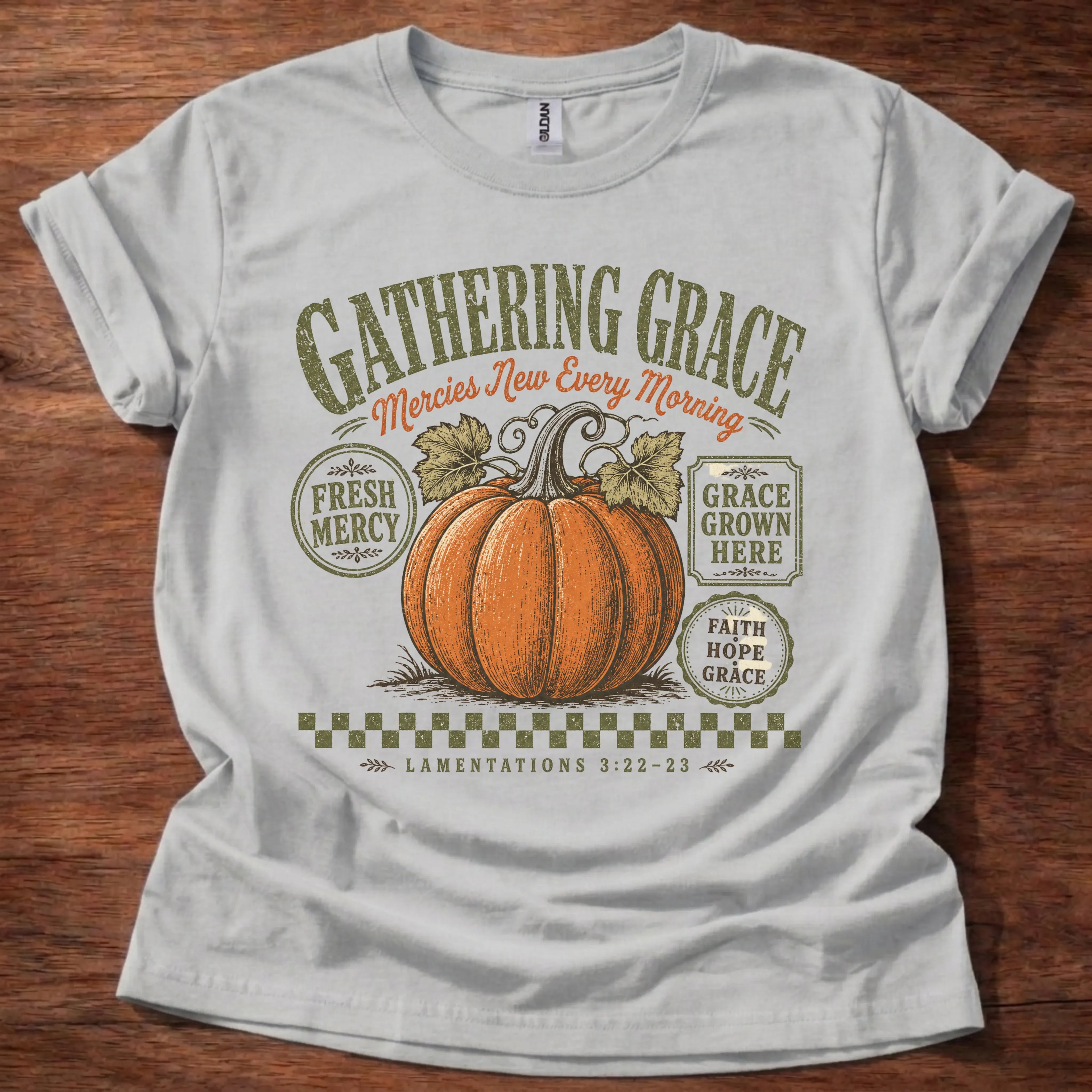 Sport grey t-shirt with a vintage farm-stand pumpkin design, arched Gathering Grace headline, and small badges reading Fresh Mercy and Grace Grown Here