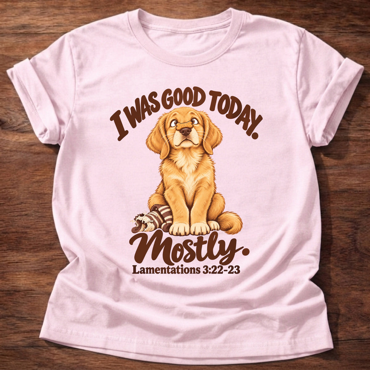 Light Pink t-shirt printed with a golden retriever puppy sitting beside a chewed-up toy and “I was good today. Mostly.” Lamentations 3:22-23 Christian shirt