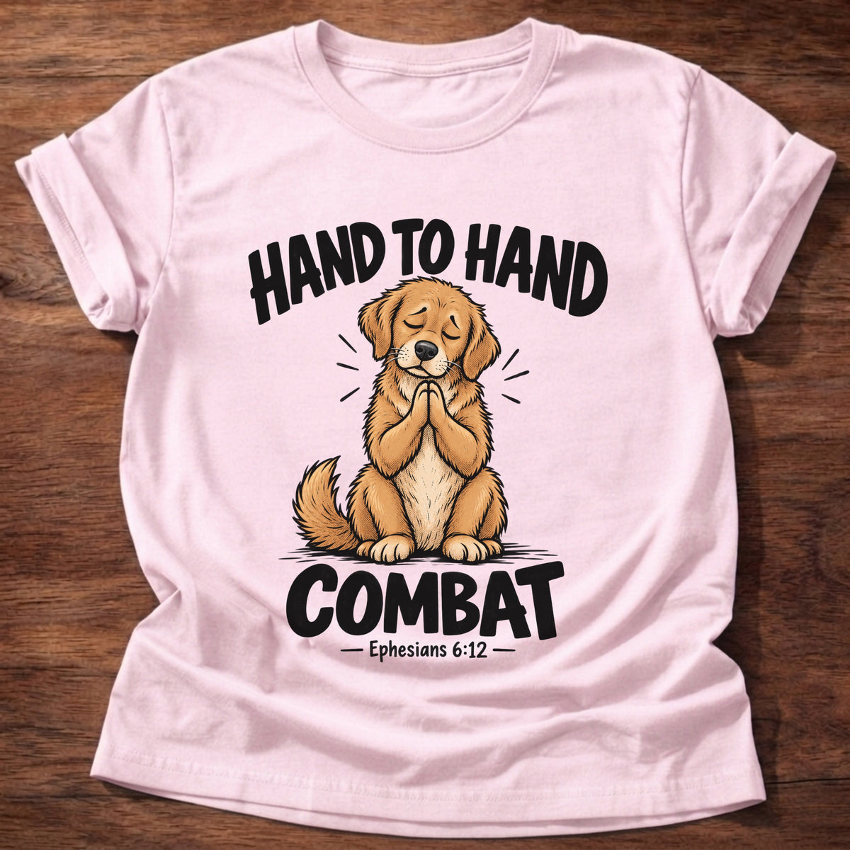 Light Pink t-shirt printed with a golden retriever puppy with eyes closed and paws folded in prayer graphic and “Hand to hand combat” Ephesians 6:12 faith based gift