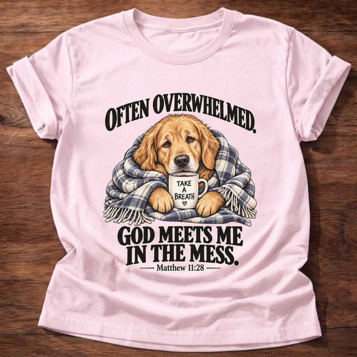 Light Pink t-shirt printed with a golden retriever wrapped in a plaid blanket holding a 'Take a Breath' mug graphic and “Often overwhelmed. God meets me in the mess.” Matthew 11:28 faith based gift