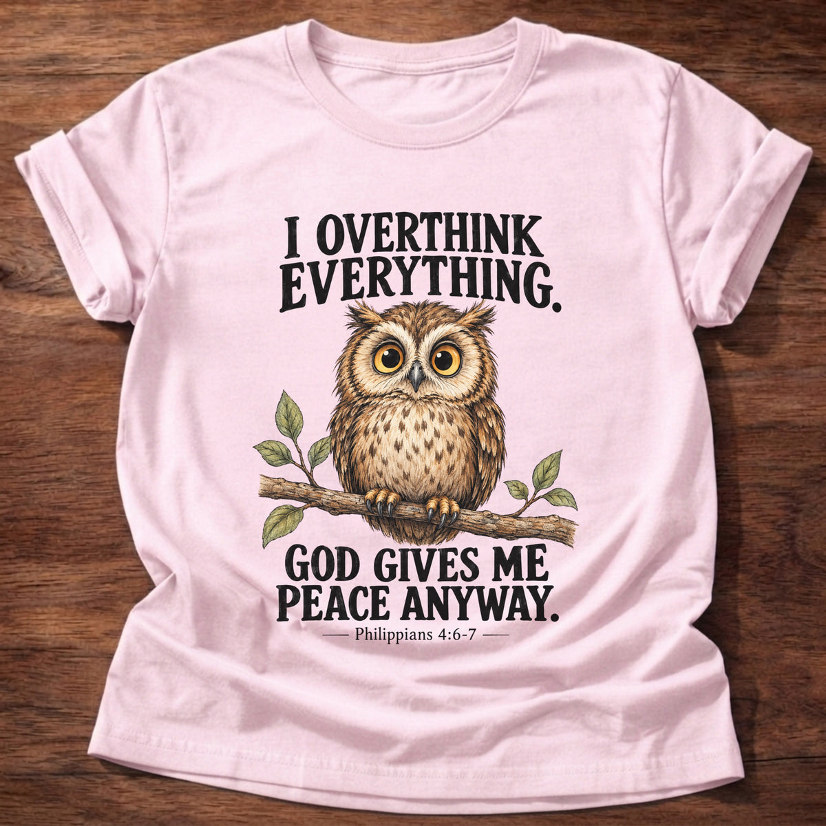 Light Pink t-shirt printed with a wide-eyed owl perched on a leafy branch graphic and “I overthink everything. God gives me peace anyway.” Philippians 4:6-7 faith based gift