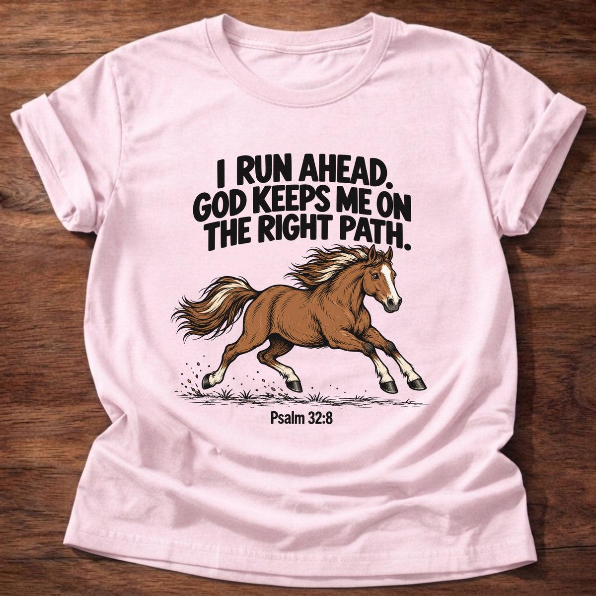 Light Pink t-shirt printed with a running horse graphic and 'I run ahead. God keeps me on the right path.' Psalm 32:8 faith based gift
