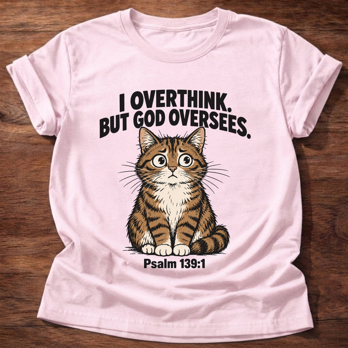 Light Pink t-shirt printed with a cat graphic and 'I overthink. But God oversees.' Psalm 139:1 faith based gift