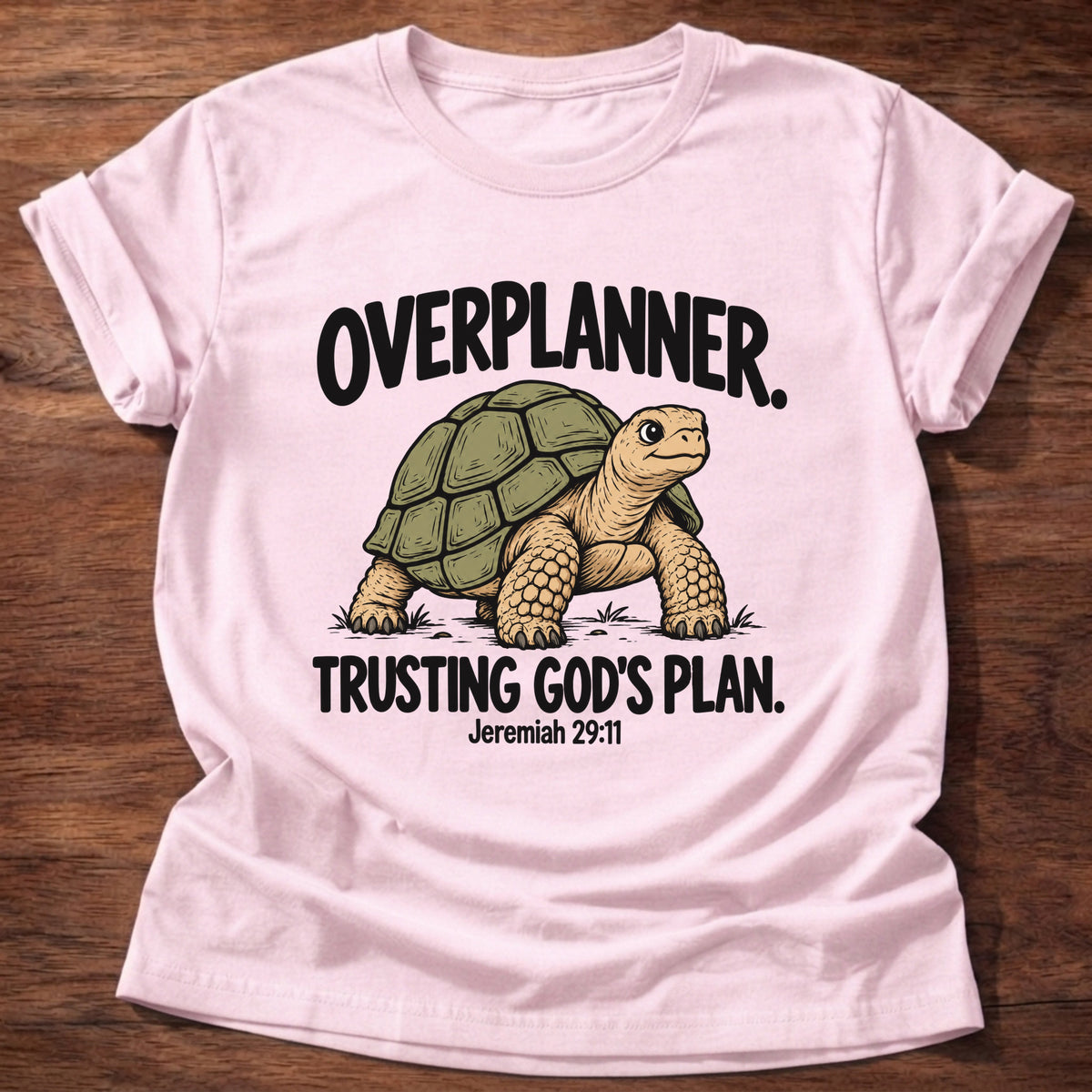 Light Pink t-shirt printed with a turtle graphic and 'Overplanner. Trusting God's plan.' Jeremiah 29:11 faith based gift