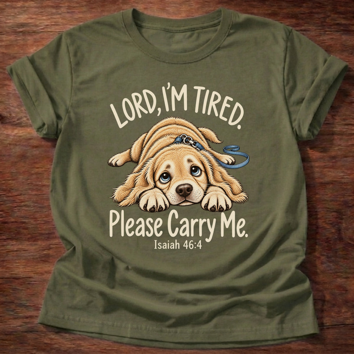 Military Green t-shirt printed with a tired puppy lying flat on the floor graphic and “Lord, I'm tired. Please carry me.” Isaiah 46:4 Christian shirt