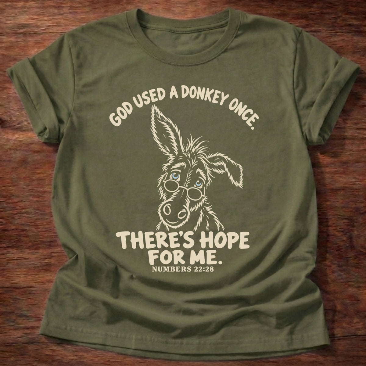 Military Green t-shirt printed with a hand-drawn donkey and “God used a donkey once. There's hope for me.” Numbers 22:28 Christian shirt