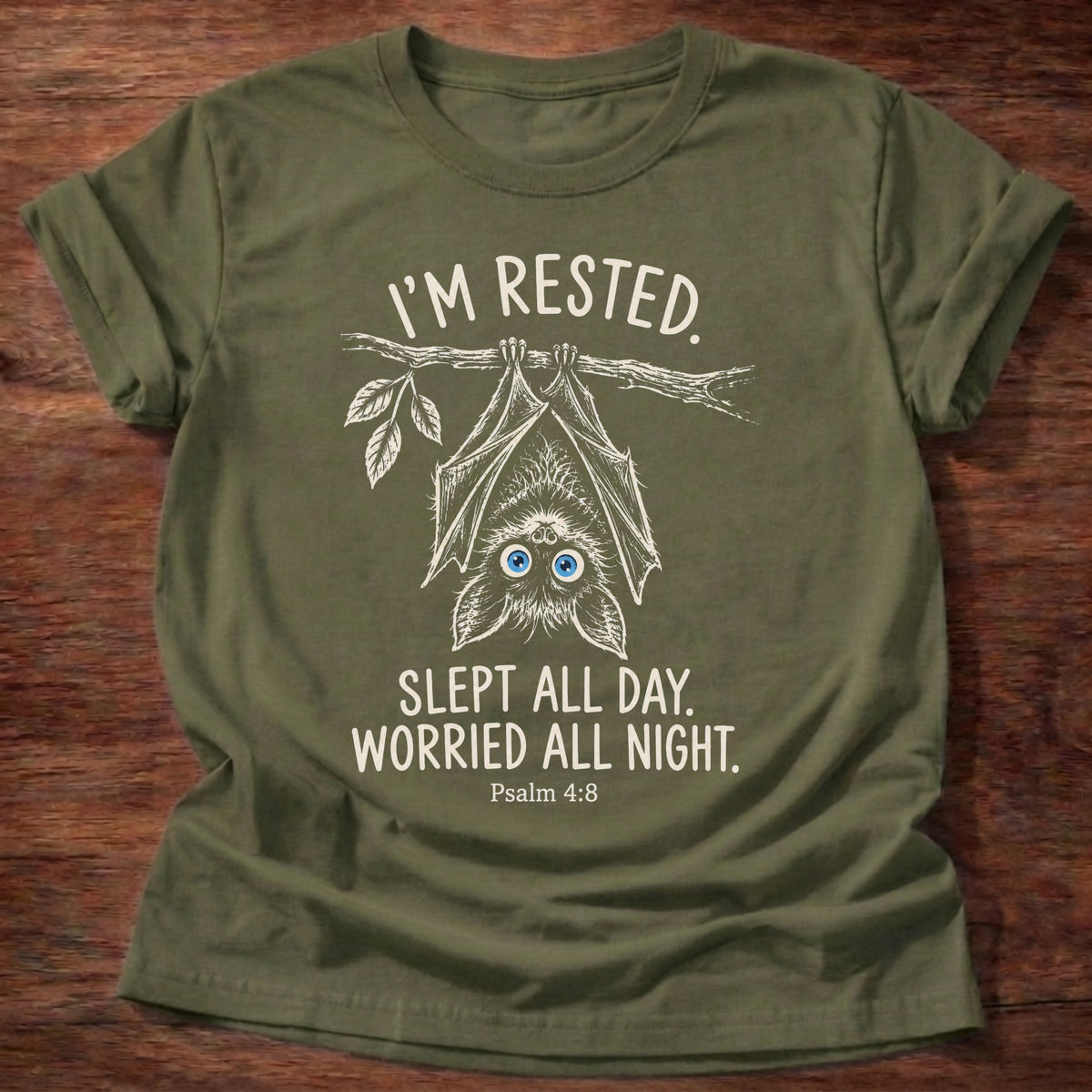Military Green t-shirt printed with an upside-down hanging bat graphic and “I'm rested. Slept all day. Worried all night.” Psalm 4:8 Christian shirt