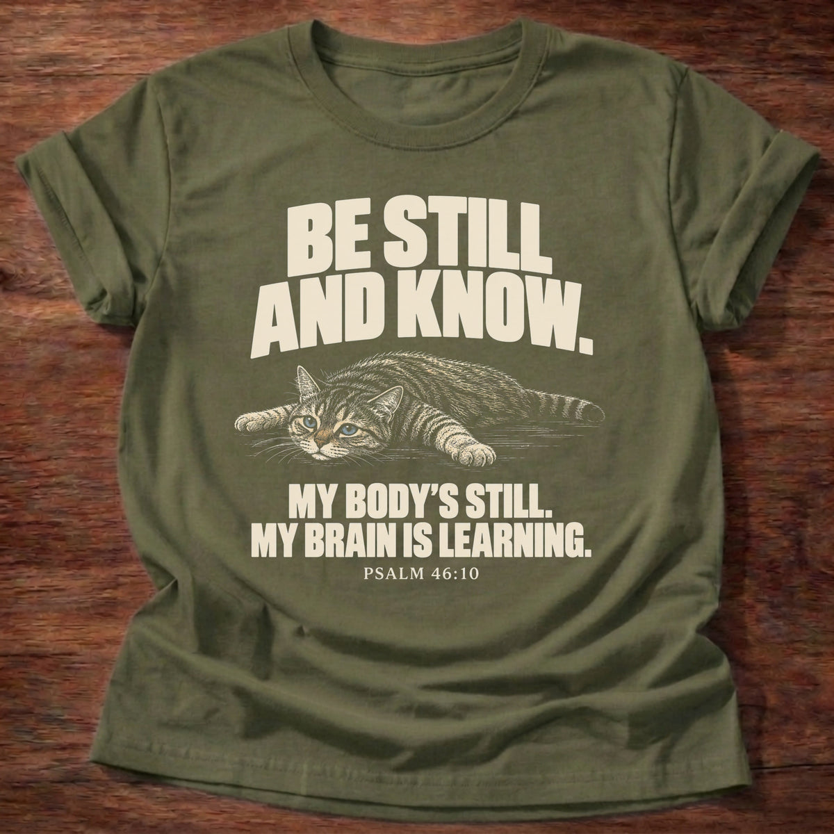 Brain Is Learning T-Shirt in Military Green featuring a relaxed cat stretched out lying down and Psalm 46:10 overthinking humor design