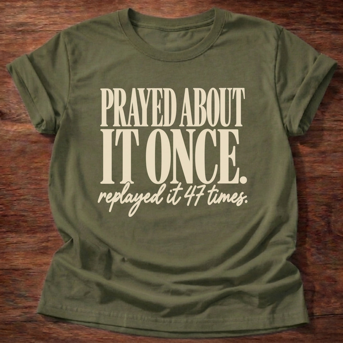 Replayed It Forty-Seven T-Shirt in Military Green featuring Prayed About It Once replayed it 47 times funny Christian overthinker typography design with script punchline