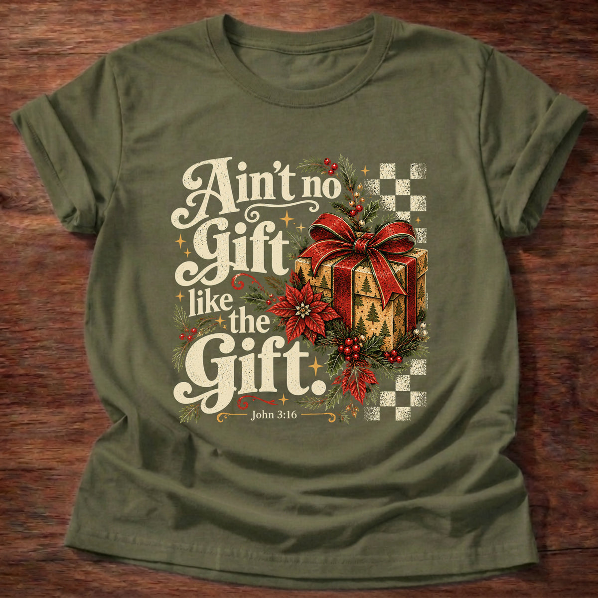 Military Green t-shirt printed with a retro wrapped Christmas present with poinsettias and checkerboard graphic and “Ain't no Gift like the Gift.” John 3:16 Christian shirt