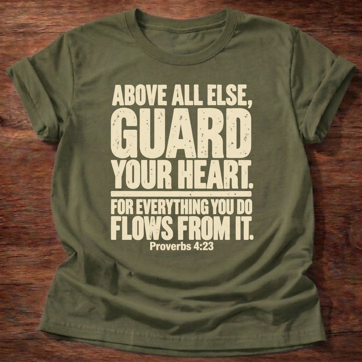 Military Green t-shirt printed with bold stacked typography graphic and “Above all else, guard your heart, for everything you do flows from it.” Proverbs 4:23 Christian shirt