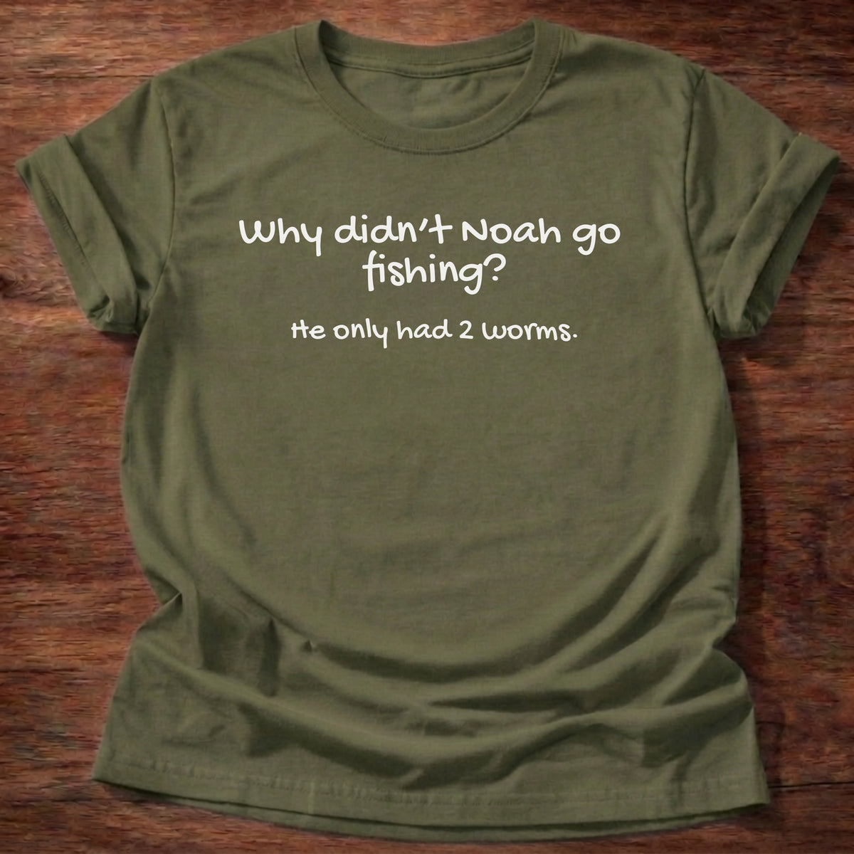 Military Green t-shirt printed with a simple hand-lettered Bible joke graphic and “Why didn't Noah go fishing? He only had 2 worms.” Genesis 7:9 Christian shirt