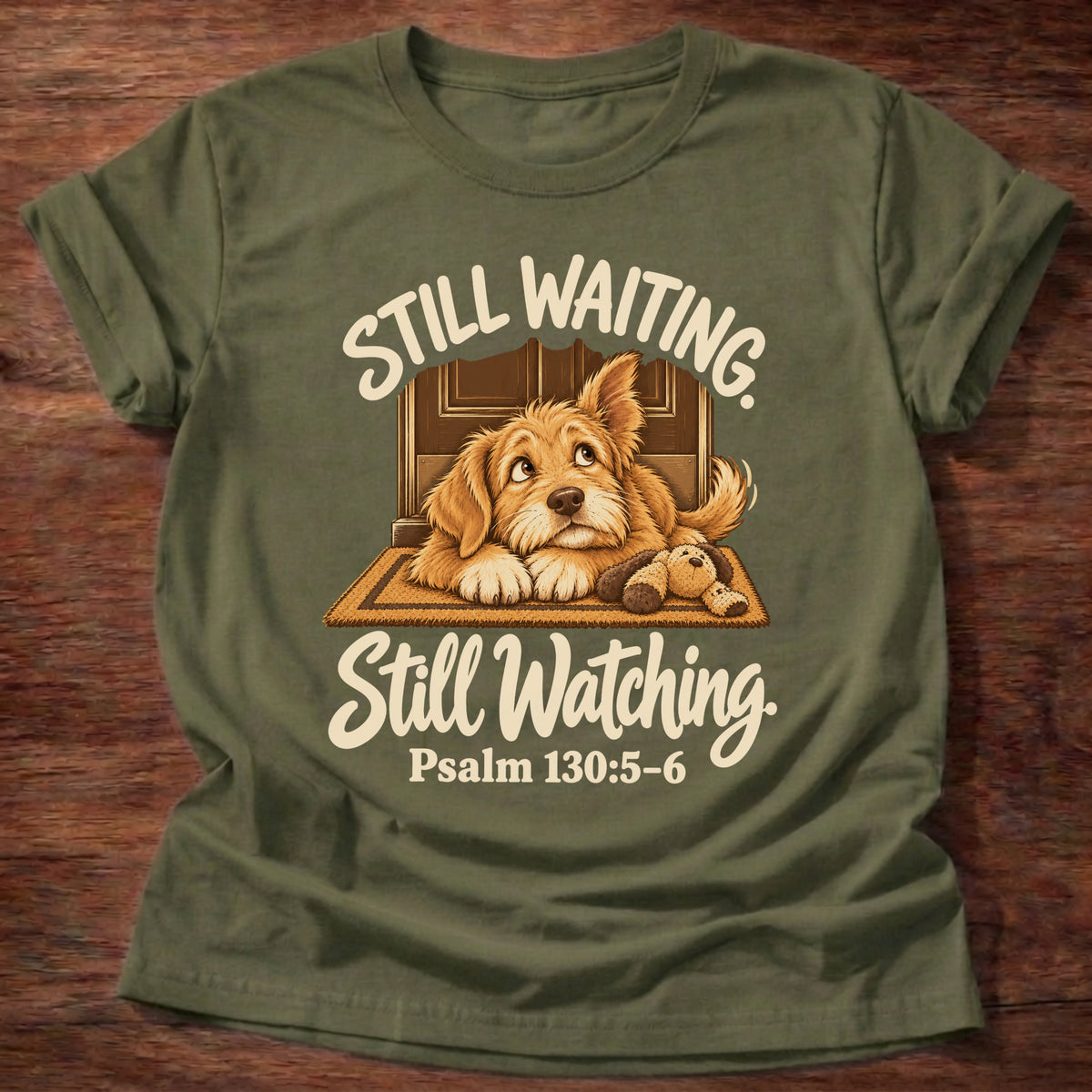 Military Green t-shirt printed with a puppy lying on a doormat waiting at the door and “Still waiting. Still watching.” Psalm 130:5-6 Christian shirt