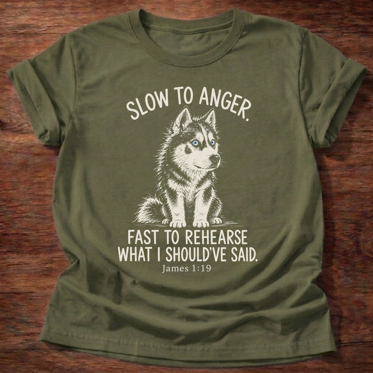 Slow To Anger T-Shirt in Military Green featuring a blue-eyed husky puppy sitting calmly and James 1:19 patience humor design