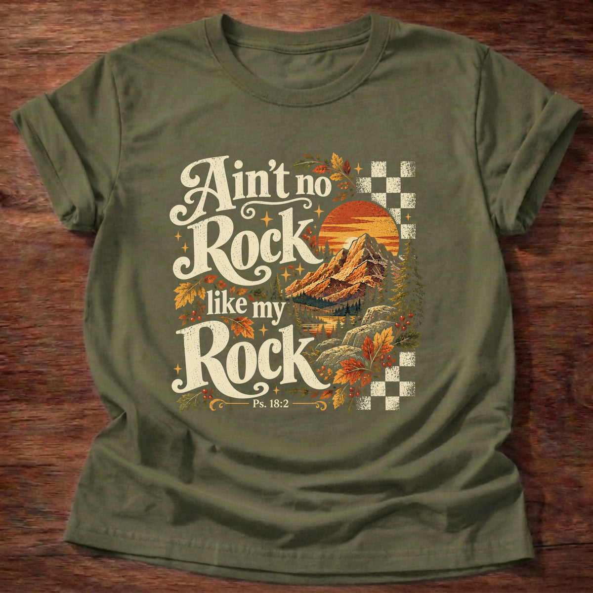 Military Green t-shirt printed with a retro mountain sunset with autumn leaves and checkerboard graphic and “Ain't no Rock like my Rock.” Psalm 18:2 Christian shirt