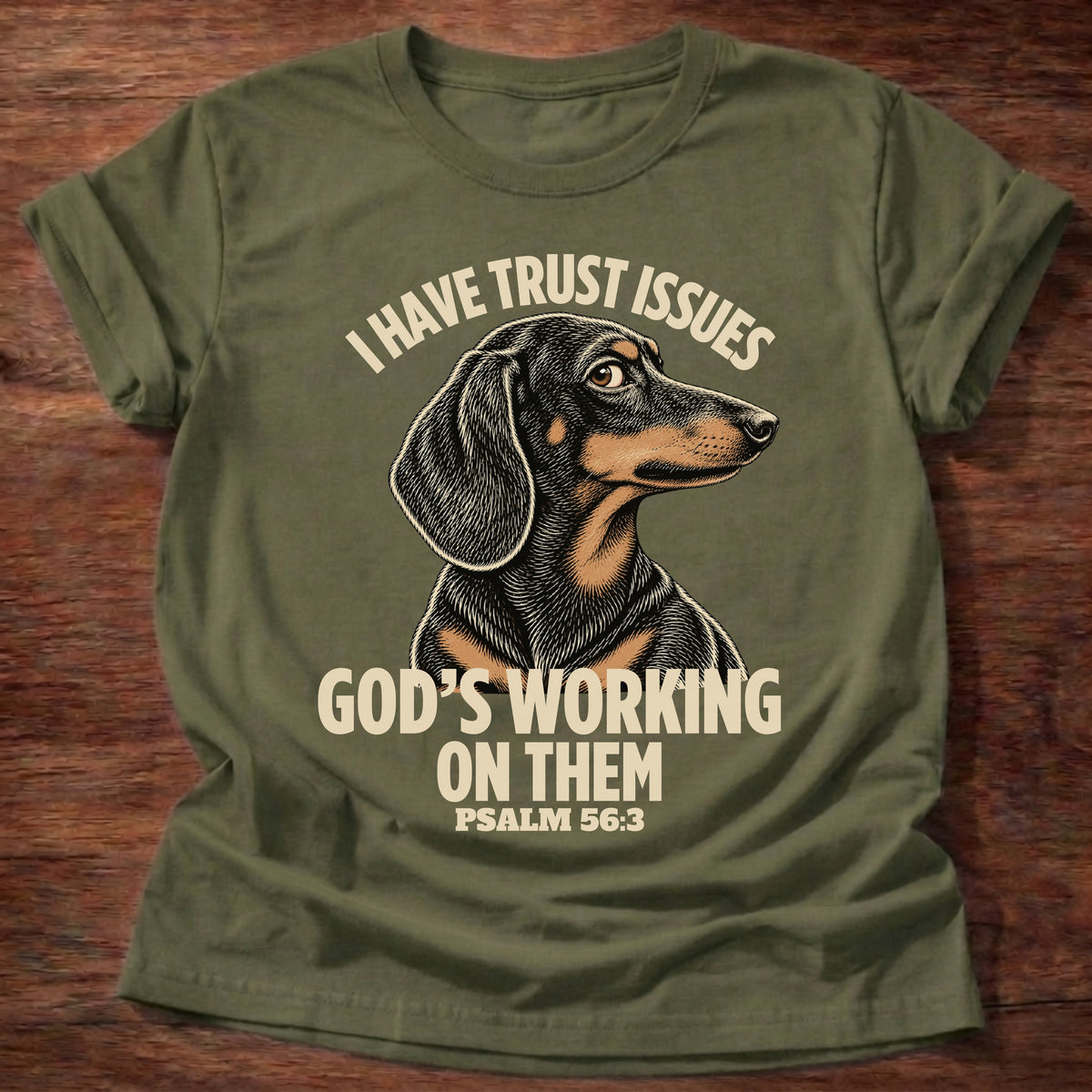 Military Green t-shirt printed with a wary dachshund puppy and “I have trust issues. God's working on them.” Psalm 56:3 Christian shirt