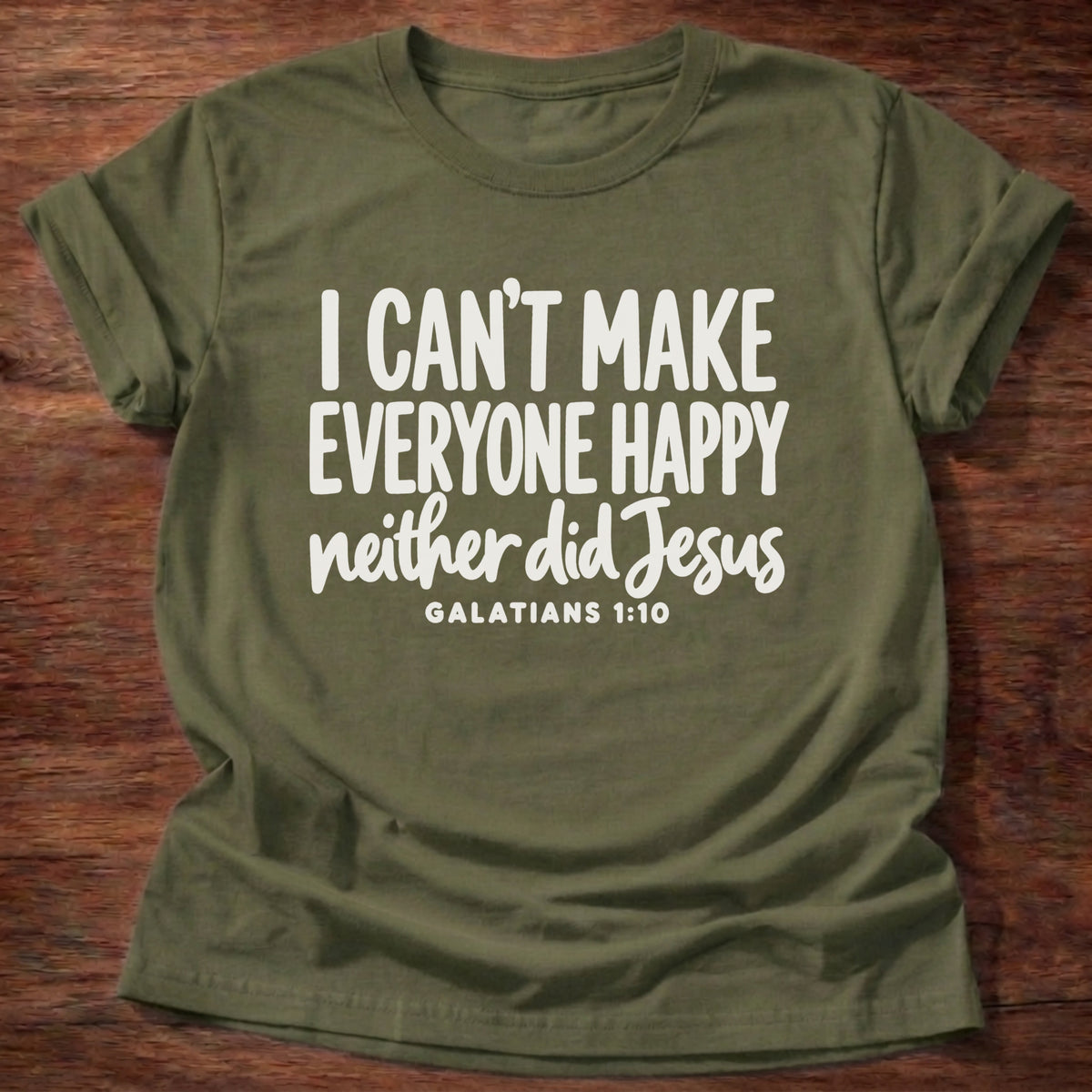 Military Green t-shirt printed with bold hand-lettered typography graphic and “I can't make everyone happy. Neither did Jesus.” Galatians 1:10 Christian shirt