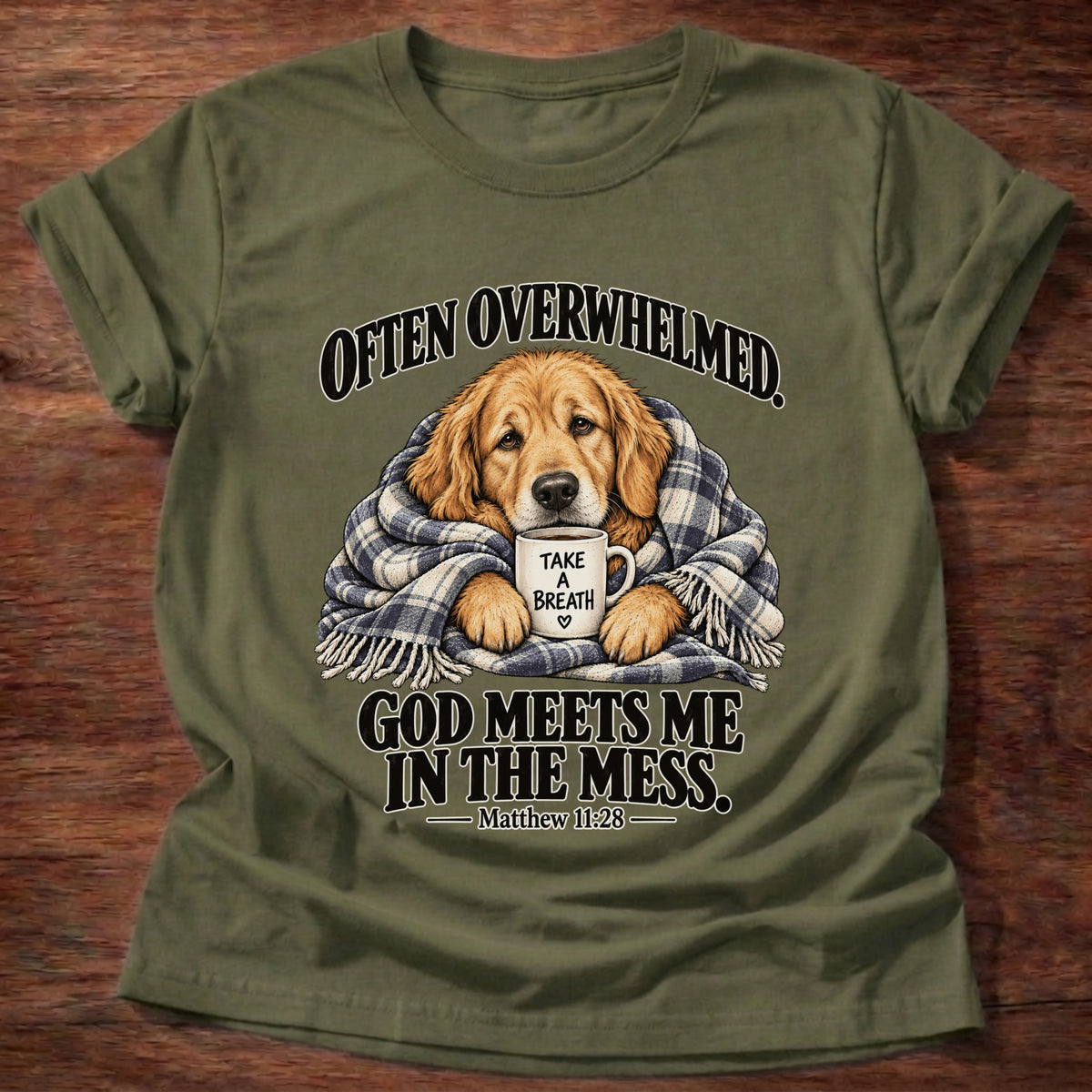 Military Green t-shirt printed with a golden retriever wrapped in a plaid blanket holding a 'Take a Breath' mug graphic and “Often overwhelmed. God meets me in the mess.” Matthew 11:28 faith based gift