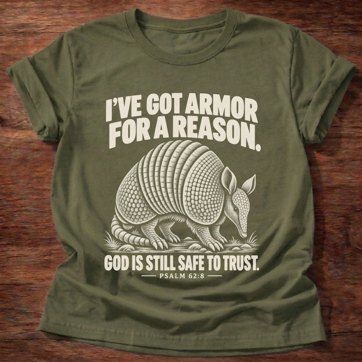 Military Green t-shirt printed with an armadillo in full armor graphic and 'I've got armor for a reason. God is still safe to trust.' Psalm 62:8 faith based gift