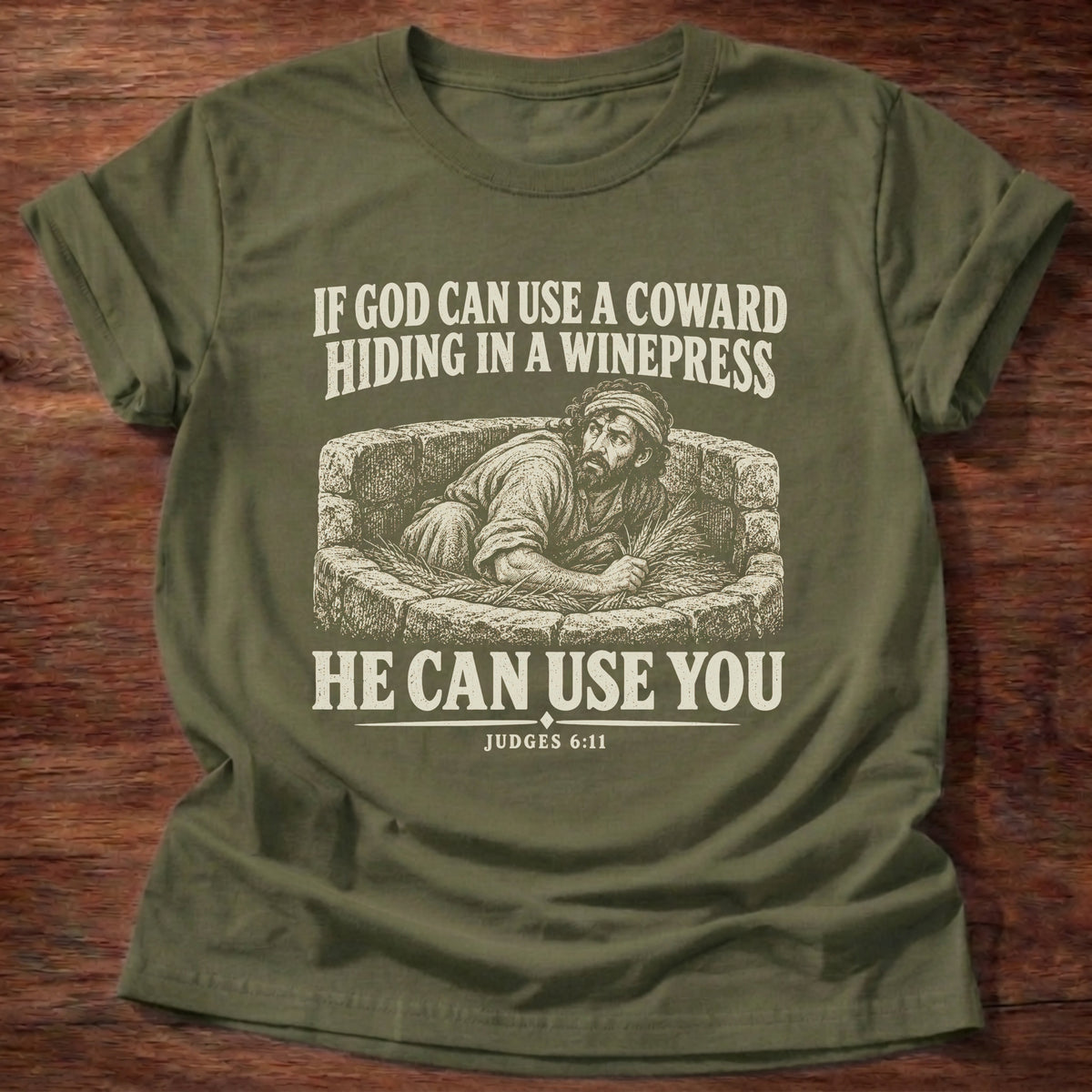 Military Green t-shirt printed with Gideon hiding in a winepress graphic and 'If God can use a coward hiding in a winepress, He can use you.' Judges 6:11 faith based gift