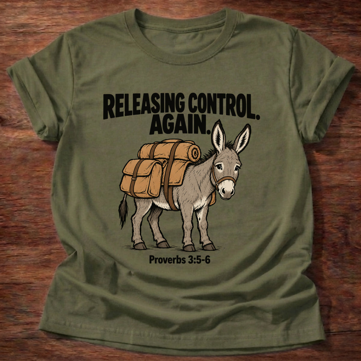 Military Green t-shirt printed with a donkey carrying a backpack graphic and 'Releasing control. Again.' Proverbs 3:5-6 faith based gift