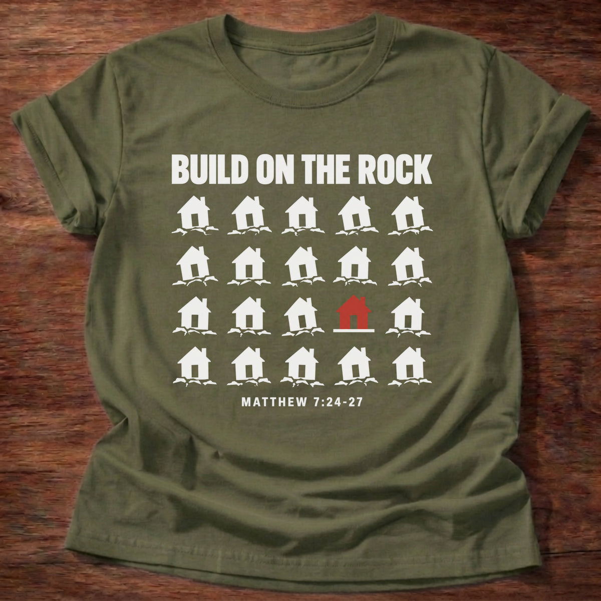 Military Green t-shirt printed with a row of houses graphic and 'Build on the rock.' Matthew 7:24-27 faith based gift
