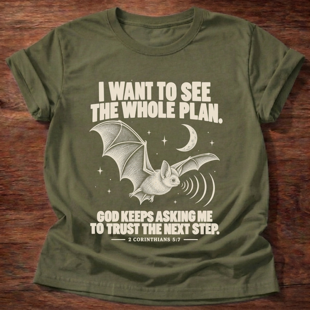 Military Green t-shirt printed with a bat flying under a night sky graphic and 'I want to see the whole plan. God keeps asking me to trust the next step.' 2 Corinthians 5:7 faith based gift