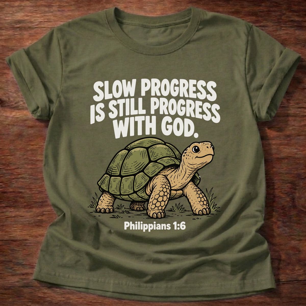Military Green t-shirt printed with a turtle graphic and 'Slow progress is still progress with God.' Philippians 1:6 faith based gift