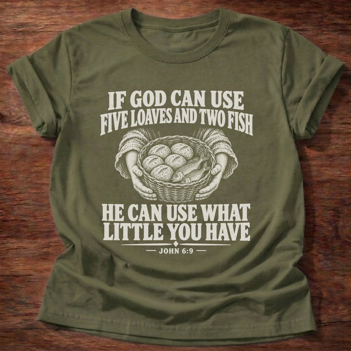 Military Green t-shirt printed with a basket of loaves and fish graphic and 'If God can use five loaves and two fish, He can use what little you have.' John 6:9 faith based gift