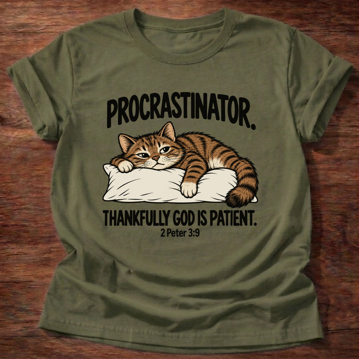 Military Green t-shirt printed with a cat sleeping on a pillow graphic and 'Procrastinator. Thankfully God is patient.' 2 Peter 3:9 faith based gift