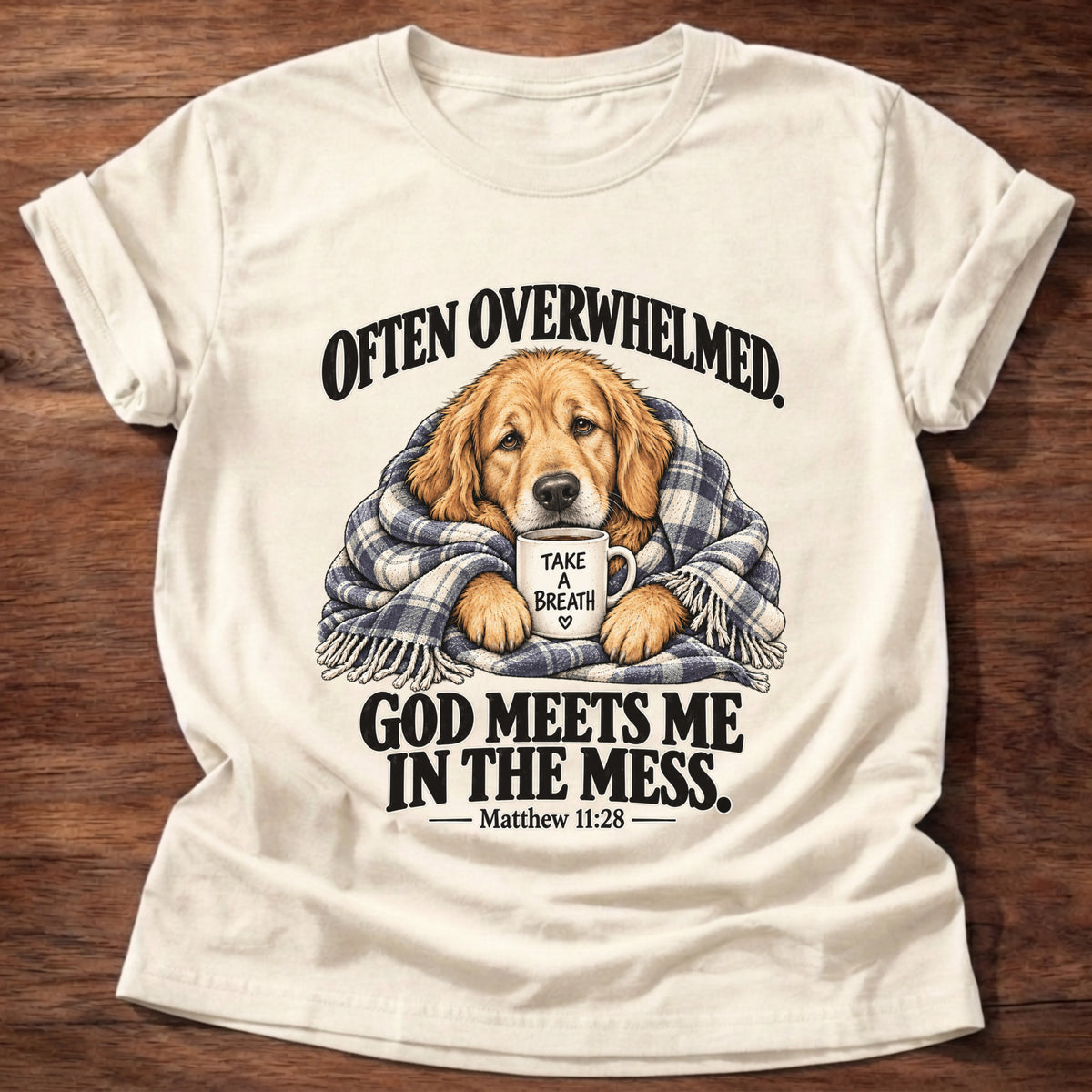 Natural t-shirt printed with a golden retriever wrapped in a plaid blanket holding a 'Take a Breath' mug graphic and “Often overwhelmed. God meets me in the mess.” Matthew 11:28 faith based gift