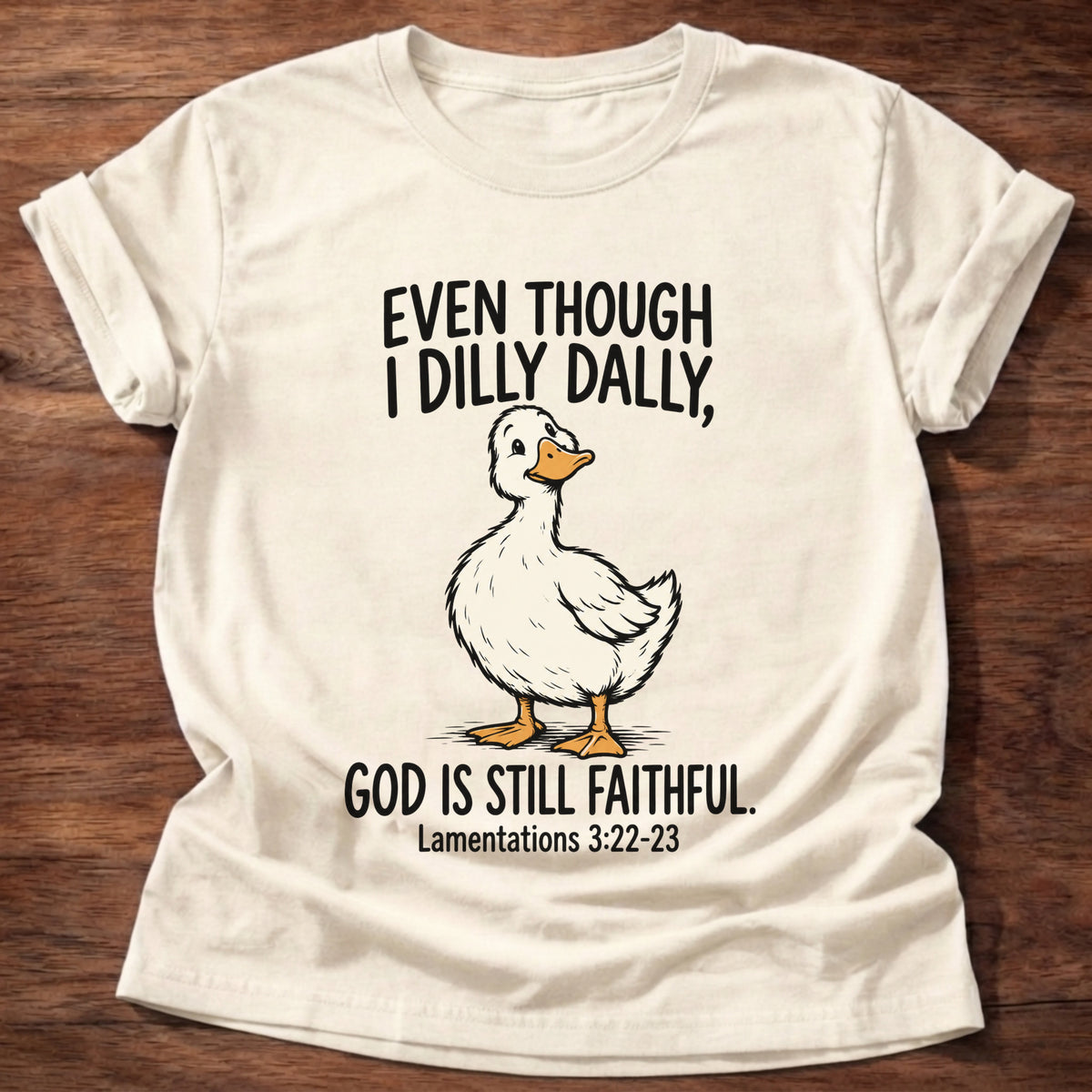 Natural t-shirt printed with a duck graphic and 'Even though I dilly dally God is still faithful.' Lamentations 3:22-23 faith based gift