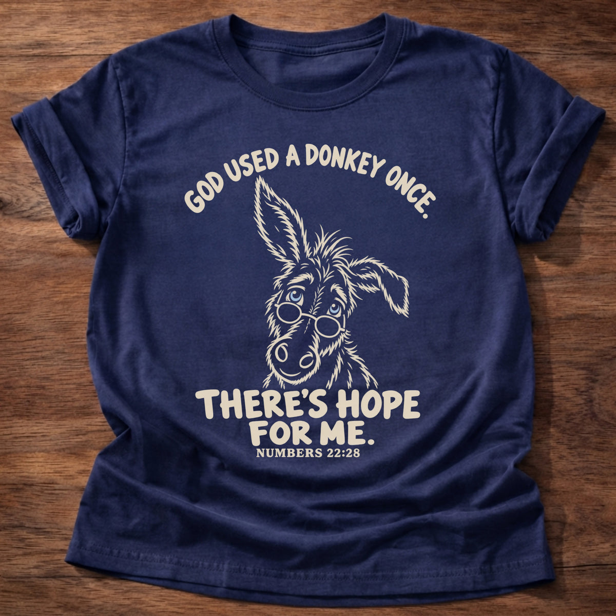 Navy t-shirt printed with a hand-drawn donkey and “God used a donkey once. There's hope for me.” Numbers 22:28 Christian shirt